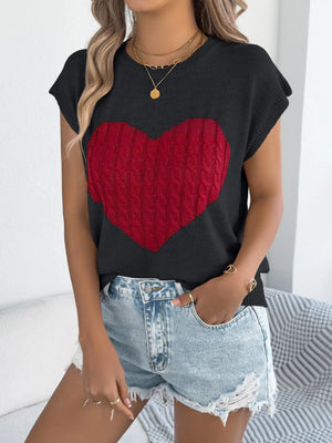 Black cable knit sweater vest with red cable knit heart graphic and short sleeves.