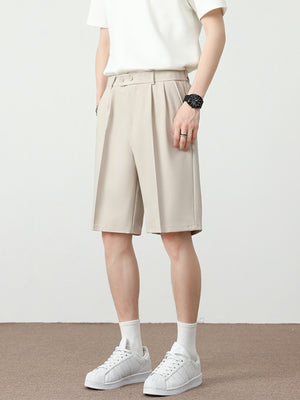 Men's cream chino shorts with pleated details and a loose fit.