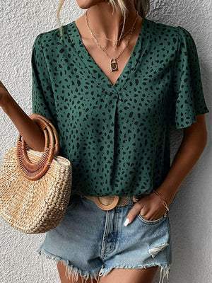 Emerald leopard print V-neck blouse with short flutter sleeves and a relaxed fit.