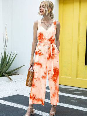 Orange tie-dye button-down jumpsuit with a belted waist and wide legs.