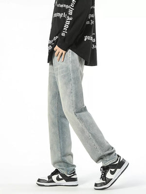 Light wash denim jeans with a loose fit and vintage wash, worn by a man.