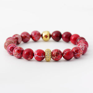 Red rainbow jasper bead bracelet with gold accents and crystal detail