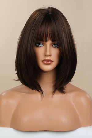 Brown bob wig with wispy bangs on a mannequin bust