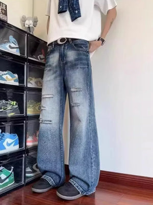 Distressed wide-leg men's jeans in blue denim with pockets and ankle pooling.