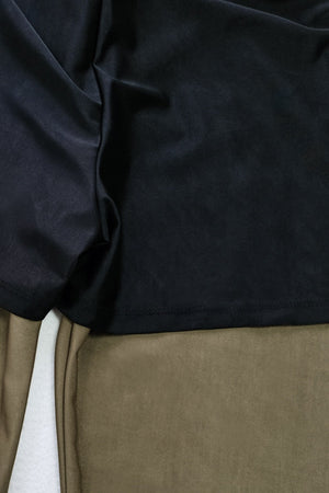 Black sporty legging swimsuit with zip detail shown up close.