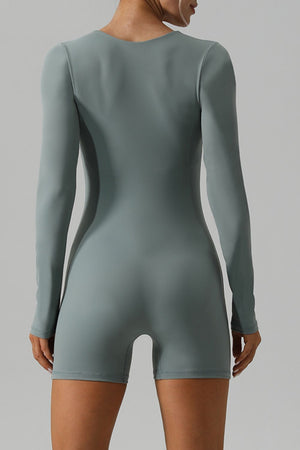Light green long sleeve unitard with a square neckline and short legs.