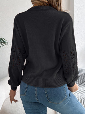 Black acrylic knit sweater with openwork detail on sleeves.
