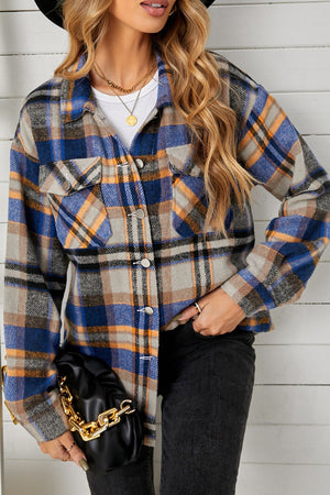 Relaxed blue and orange plaid shacket with buttoned patch pockets and a collared neckline.