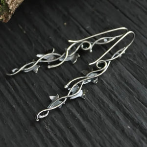 Silver ivy vine drop earrings with small gemstone accents.