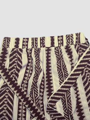 Geometric print maternity pants in black and white with a tie bow detail.