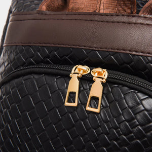Black woven faux leather convertible backpack with gold zipper details and brown accents.