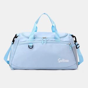Pastel blue nylon duffle bag with dual handles, adjustable strap, and mesh pocket detail.