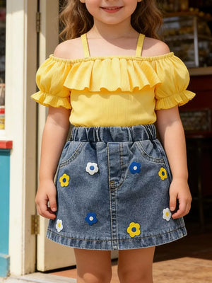 Yellow ruffled off-shoulder top with puff sleeves and denim A-line skirt with flower appliques.