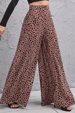 Spotted wide-leg palazzo trousers in dusty pink with a high waist and flowing silhouette.