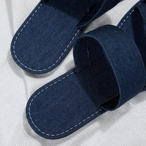 Dark blue crisscross toe loop sandals with white stitching detail.