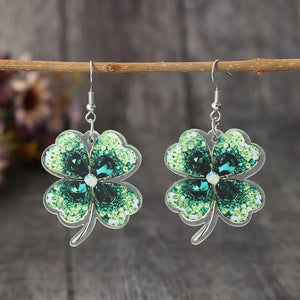 Dark green acrylic clover earrings with gemstone accents.
