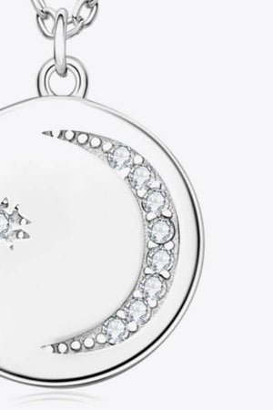 Silver pendant necklace with celestial moon and star design featuring clear crystals
