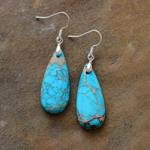 Turquoise vein teardrop dangle earrings with silver hooks.
