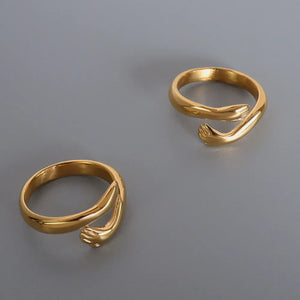 Gold embracing hands open ring with detailed fingertips