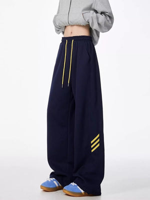 Navy sweatpants with yellow drawstring and side stripes, relaxed fit.