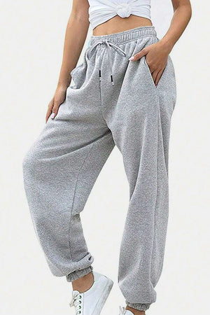 Light gray relaxed-fit cuffed sweatpants with drawstring and pockets.