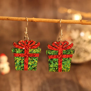Green glitter gift box drop earrings with red ribbon detail.