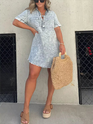 Short sleeve denim wash dress with pockets and raw hem, styled with wedges and a straw bag.