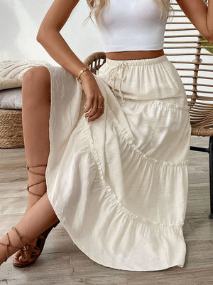 Cream tiered midi skirt with drawstring waist and textured fabric.