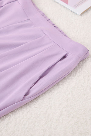 Lavender pleated trousers with a pocket detail and elastic waistband.
