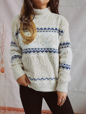 Geometric knit mockneck pullover in cream with blue zigzag pattern, acrylic blend.