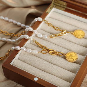 Gold pearl and coin link necklace with baroque pearls and oval chain links.