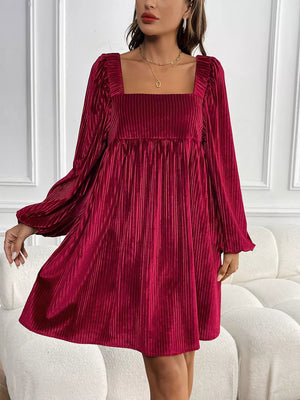 Chic velvet mini dress with square neckline and pleated detail.