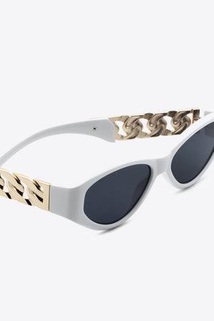 White frame cat-eye sunglasses with gold chain detail and dark lenses.