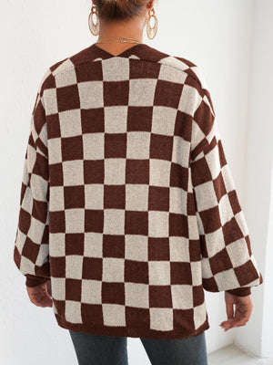 Checkerboard knit cardigan in brown and white with balloon sleeves and a V-neck.