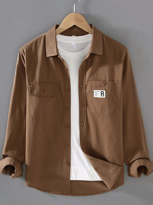 Brown cotton long-sleeve overshirt with two chest pockets and buttoned front.