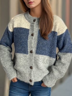 Colorblock crewneck button-down acrylic cardigan in Dusty Blue and Gray with cream accents.