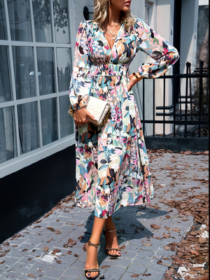 Floral print midi dress with V-neck, long sleeves, and smocked waist.