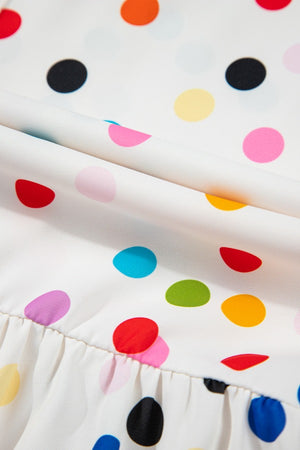 White blouse with rainbow polka dots and ruffled hem detail.