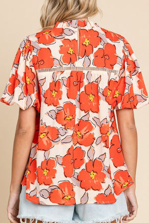 Floral print blouse in caramel with flutter sleeves and a keyhole back detail.