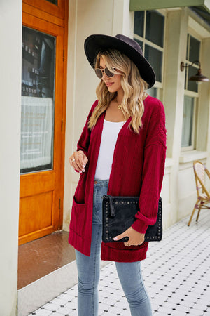 Wine cable-knit cardigan with pockets and chevron pattern, open front.