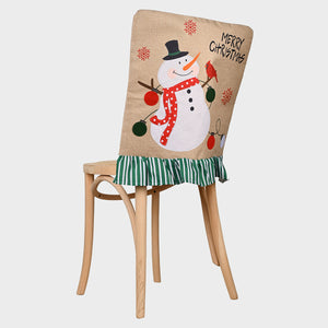 Christmas chair cover with snowman, lights, and ruffled green striped trim.