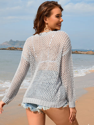 Light gray open-knit beach sweater with ribbed trim and long sleeves.
