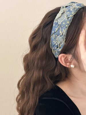 Braided denim headband with gold starburst pattern and scalloped trim.