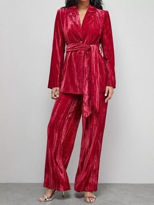 Burgundy velvet belted blazer and wide leg trousers ensemble