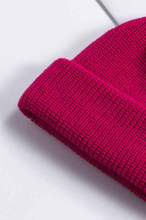 Ribbed knit beanie in magenta with a turned-up brim.