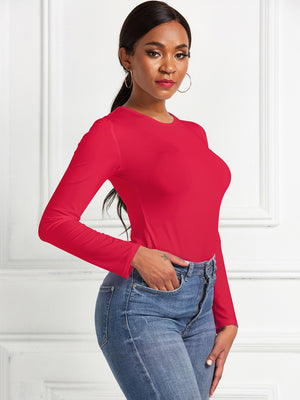 Red long sleeve ribbed bodysuit with crew neck, styled with jeans.