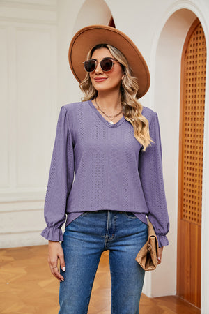 Lilac perforated sleeve blouse with ruffle cuffs and V-neck.