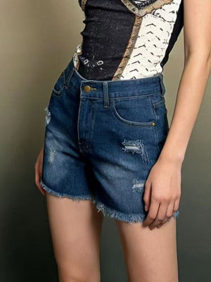 Dark blue distressed denim shorts with frayed hem and high waist.