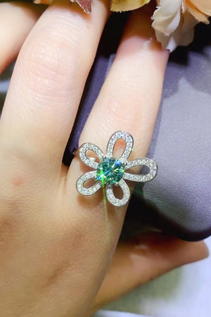 Petal Halo ring with teal moissanite center and diamond accent petals.