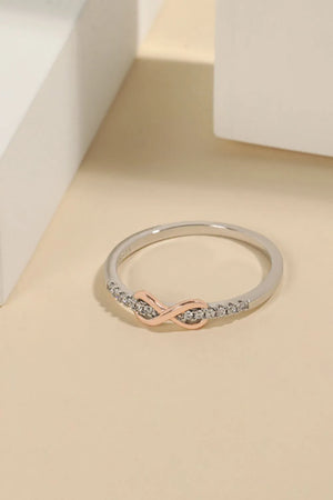 Silver ring with rose gold infinity knot and pavé crystals
